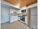 Modern white kitchen with stainless steel appliances at 201 S Hoskins Rd # 122, Charlotte, NC 28208