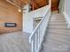 Open living area with loft, fireplace, and wood wall at 201 S Hoskins Rd # 122, Charlotte, NC 28208