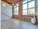 Large living room with hardwood floors and brick wall at 201 S Hoskins Rd # 122, Charlotte, NC 28208