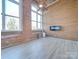 Living room with hardwood floors, fireplace and wood wall at 201 S Hoskins Rd # 122, Charlotte, NC 28208