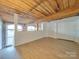 Loft bedroom with exposed wooden beams and large windows at 201 S Hoskins Rd # 122, Charlotte, NC 28208