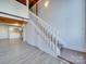 Modern white staircase leading to upper loft with kitchen view at 201 S Hoskins Rd # 122, Charlotte, NC 28208