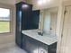 Bathroom with dark vanity, quartz countertop, and large mirror at 226 Beths Ct, York, SC 29745