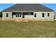 Rear view of a house showing a deck and grassy backyard at 226 Beths Ct, York, SC 29745