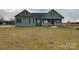 Welcoming facade with a classic covered porch, green siding, and a sprawling front yard at 226 Beths Ct, York, SC 29745