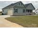 Home showcasing a side-entry garage, green siding, and a neatly kept lawn at 226 Beths Ct, York, SC 29745