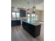 Modern kitchen featuring island, granite countertops, and dark cabinetry at 226 Beths Ct, York, SC 29745