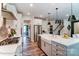 Modern kitchen with island, stainless steel appliances, and white cabinets at 3226 Mcharney Dr # 35, Harrisburg, NC 28075