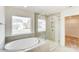 Spa-like bathroom featuring a soaking tub and a glass shower at 3229 Mcharney Dr # 35, Harrisburg, NC 28075