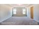 Large bedroom with two windows and carpet at 3229 Mcharney Dr # 35, Harrisburg, NC 28075