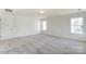 Well-lit bedroom with neutral walls and carpet at 3229 Mcharney Dr # 35, Harrisburg, NC 28075