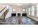 Gathering room with hardwood floors, fireplace and staircase at 3229 Mcharney Dr # 35, Harrisburg, NC 28075