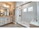 Bathroom with white tile shower, built in seat, and double vanity at 3237 Mcharney Dr # 29, Harrisburg, NC 28075