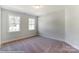 Well-lit bedroom with neutral walls and carpet at 3237 Mcharney Dr # 29, Harrisburg, NC 28075