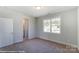 Bright bedroom with neutral walls and carpet, featuring a window and access to a bathroom at 3237 Mcharney Dr # 29, Harrisburg, NC 28075