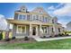 Two-story house with gray siding, stone accents, and a front porch at 3237 Mcharney Dr # 29, Harrisburg, NC 28075