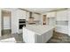 Modern kitchen with white cabinets and large island at 3237 Mcharney Dr # 29, Harrisburg, NC 28075