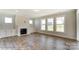 Bright living room with hardwood floors, fireplace, and large windows at 3237 Mcharney Dr # 29, Harrisburg, NC 28075