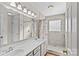 Main bathroom with double sinks, shower, and tile flooring at 415 Cameron Dr, Salisbury, NC 28147