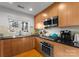 Modern kitchen with stainless steel appliances and wood cabinets at 420 Queens Rd # 6, Charlotte, NC 28207