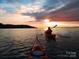 Two kayaks glide across calm water at sunset at 4339 Reed Creek Dr, Sherrills Ford, NC 28673