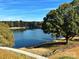 Tranquil lake view with mature trees and a clear blue sky at 4339 Reed Creek Dr, Sherrills Ford, NC 28673