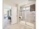 Modern bathroom with a glass shower, and view into bedroom at 4580 Potters Wheel Dr, Fort Mill, SC 29715