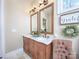 Double vanity bathroom with marble countertops, elegant mirrors, and decorative artwork at 600 E Monbo Rd, Statesville, NC 28677