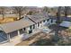 Aerial view of a white home with a dark roof, covered parking, and large backyard at 6211 Rock Island Rd, Charlotte, NC 28278