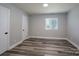 Simple bedroom with gray walls and wood-look floors at 6211 Rock Island Rd, Charlotte, NC 28278