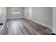 Spacious bedroom featuring light gray walls and wood-look flooring at 6211 Rock Island Rd, Charlotte, NC 28278