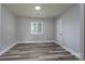 Simple bedroom with gray walls and wood-look floors at 6211 Rock Island Rd, Charlotte, NC 28278