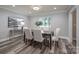 Elegant dining room with hardwood floors and modern light fixture at 6211 Rock Island Rd, Charlotte, NC 28278