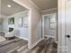 Bright hallway with hardwood floors, leading to living room and other areas of the home at 6211 Rock Island Rd, Charlotte, NC 28278