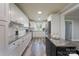 Modern kitchen with white cabinets, granite countertops, and stainless steel appliances at 6211 Rock Island Rd, Charlotte, NC 28278