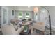 Relaxing sunroom featuring comfortable seating and natural light at 6211 Rock Island Rd, Charlotte, NC 28278