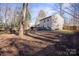 Large backyard with wooden deck and wooded area at 6619 Wagon Oak Rd, Charlotte, NC 28212