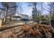 Spacious backyard with lush greenery and a stone pot at 6619 Wagon Oak Rd, Charlotte, NC 28212