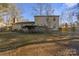 Home's backyard with deck and grassy area at 6619 Wagon Oak Rd, Charlotte, NC 28212