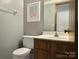 Bathroom with toilet, sink, and vanity at 6619 Wagon Oak Rd, Charlotte, NC 28212