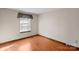 Simple bedroom with wood floors and a window at 6619 Wagon Oak Rd, Charlotte, NC 28212