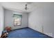 Simple bedroom with blue carpet and ceiling fan at 6619 Wagon Oak Rd, Charlotte, NC 28212