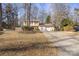 House exterior showcasing a two-car garage and a spacious yard at 6619 Wagon Oak Rd, Charlotte, NC 28212