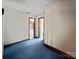 Hallway with blue carpet and access to rooms at 6619 Wagon Oak Rd, Charlotte, NC 28212