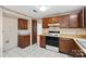 Efficient kitchen with wood cabinets, tiled floor and appliances at 6619 Wagon Oak Rd, Charlotte, NC 28212