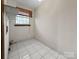 Laundry room with window and shelving at 6619 Wagon Oak Rd, Charlotte, NC 28212