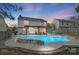 Stunning pool at dusk with pergola and patio furniture at 7647 Black Hawk Ln, Tega Cay, SC 29708