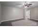 Spacious bedroom with ceiling fan, neutral walls, and wood-look flooring at 7704 Woodland Hills Rd, Hickory, NC 28602