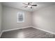 Bedroom with grey wood-look floors and ceiling fan at 7704 Woodland Hills Rd, Hickory, NC 28602