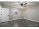 Bedroom with ceiling fan and grey wood-look floors at 7704 Woodland Hills Rd, Hickory, NC 28602